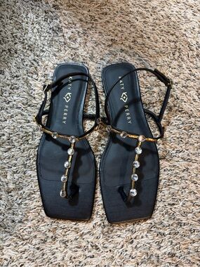 Katy Perry Collections Black T-Strap Sandals with Gold Accents & Clear Gems
